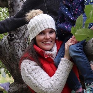 Hand crafted cable knit hat with faux fur puff